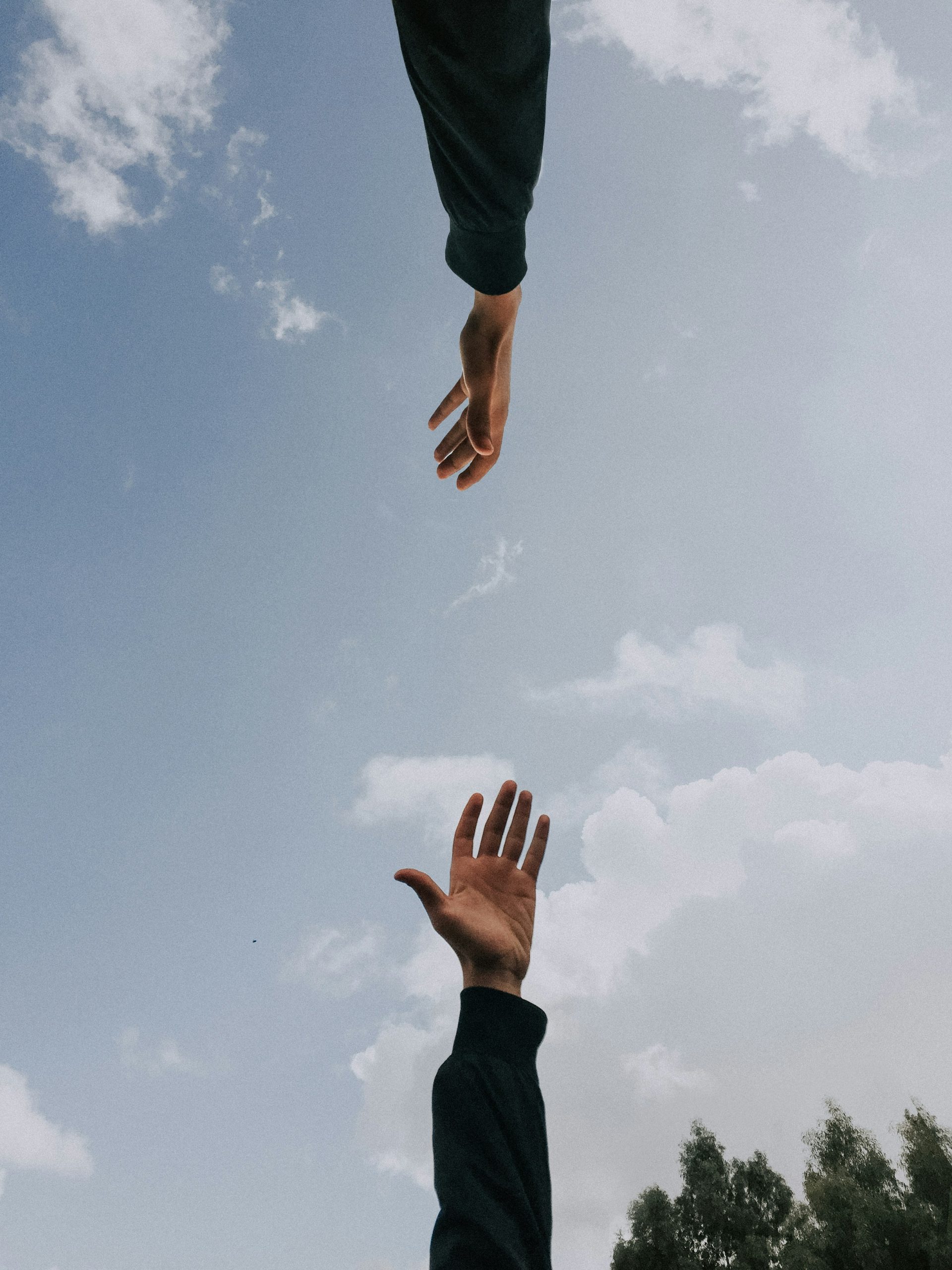 Two hands reaching towards each other